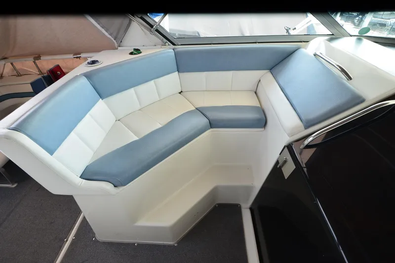Slide: The Image of 1990 Slick Craft 310 SC boat interior with blue and white cushioned seating. - 11