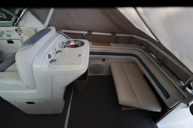 Slide: The Image of 1990 Slick Craft 310 SC boat interior with seating, sink, and storage area. - 13