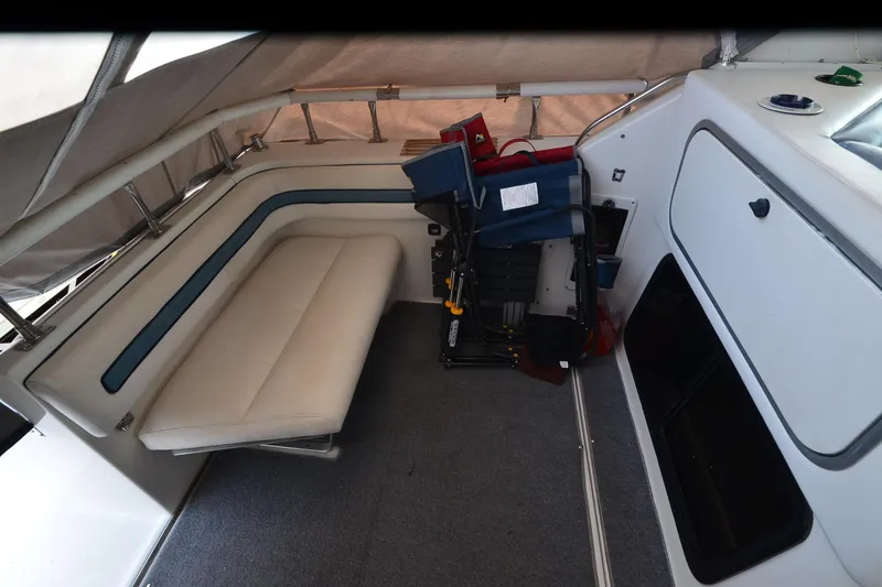 Slide: The Image of 1990 Slick Craft 310 SC boat interior with white seating and storage compartments. - 14