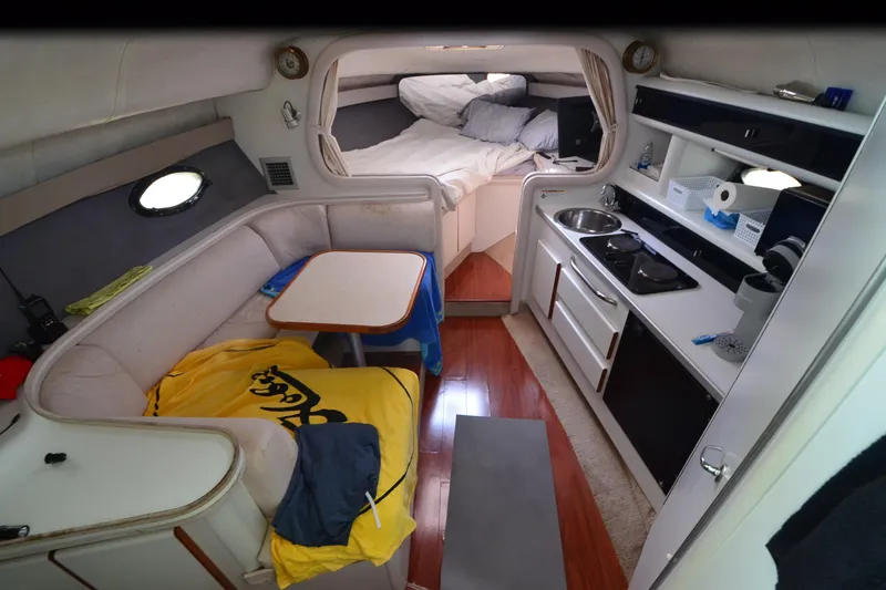 Slide: The Image of Interior of 1990 Slick Craft 310 SC boat with cozy seating and compact kitchen. - 15
