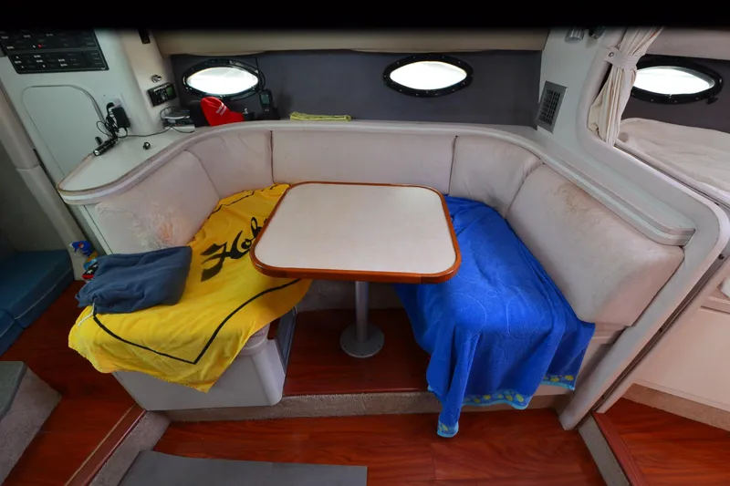 Slide: The Image of Interior of 1990 Slick Craft 310 SC boat with cozy seating and table. - 18