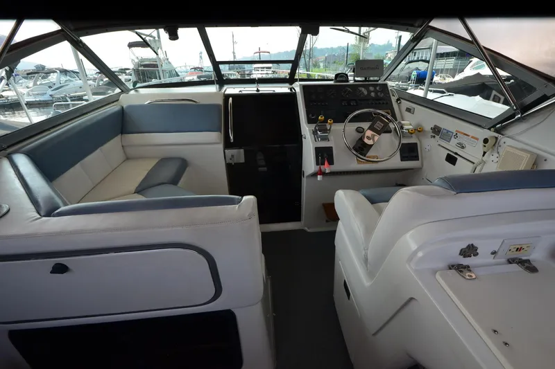 Slide: The Image of 1990 Slick Craft 310 SC boat interior with steering wheel and seating area. - 6