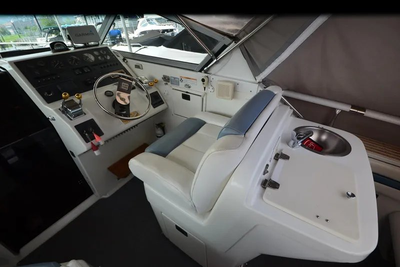 Slide: The Image of 1990 Slick Craft 310 SC boat cockpit with steering wheel, control panel, and sink. - 7