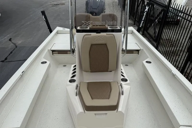 Slide: The Image of 2026 Xpress H22B boat interior with beige seating and console, showcasing modern design. - 11