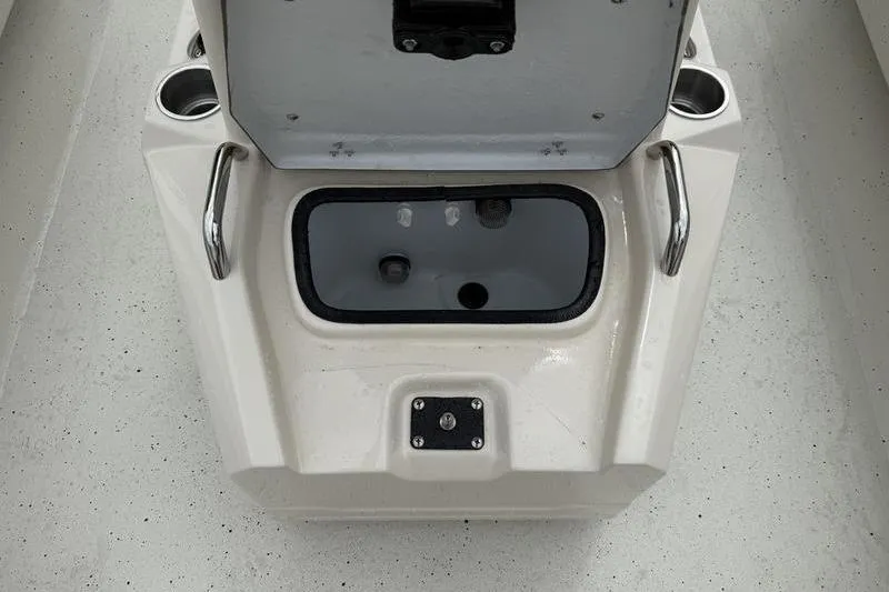 Slide: The Image of Open storage compartment on 2026 Xpress H22B boat with cup holders and handles. - 12