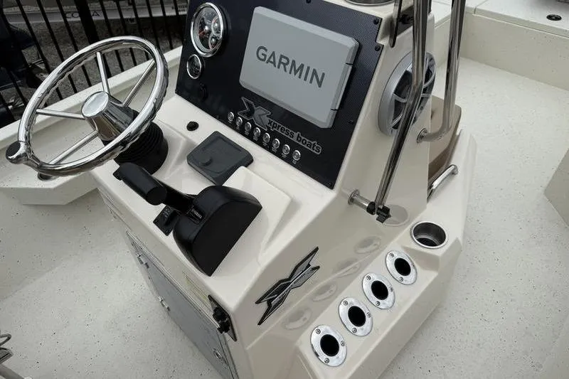 Slide: The Image of 2026 Xpress H22B boat console with Garmin navigation system and steering wheel. - 13