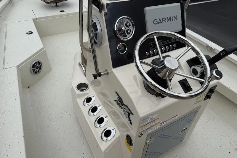 Slide: The Image of 2026 Xpress H22B boat console with Garmin navigation and steering wheel. - 14
