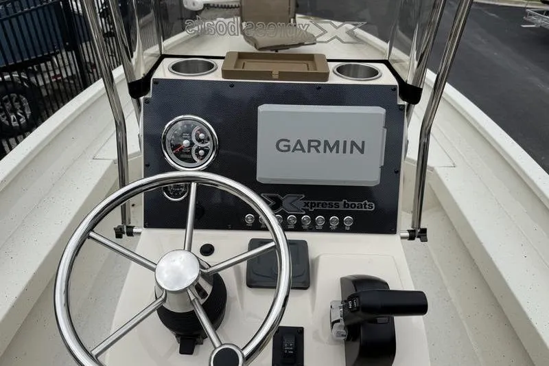 Slide: The Image of 2026 Xpress H22B boat dashboard with Garmin navigation system and steering wheel. - 15