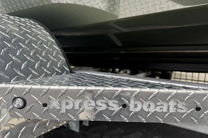Slide: The Image of 2026 Xpress H22B boat trailer with diamond plate design and "Xpress Boats" branding. - 19