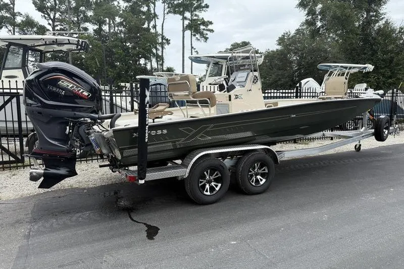 Slide: The Image of 2026 Xpress H22B boat on trailer with Yamaha engine, parked outdoors. - 3