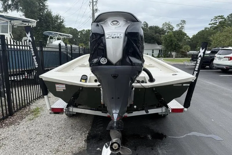 Slide: The Image of 2026 Xpress H22B boat with powerful outboard motor, parked on a trailer. - 5