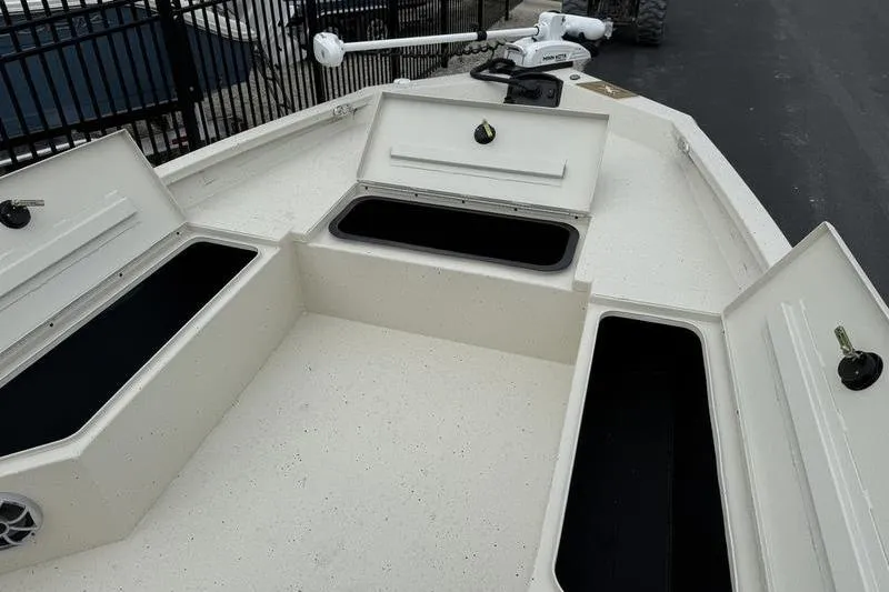 Slide: The Image of 2026 Xpress H22B boat with open storage compartments on deck. - 8