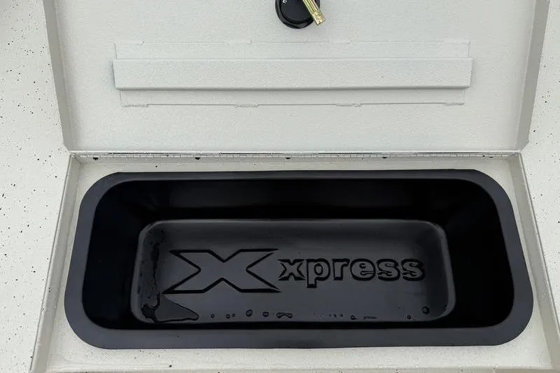 Slide: The Image of Xpress H22B 2026 boat storage compartment with logo and key lock. - 9