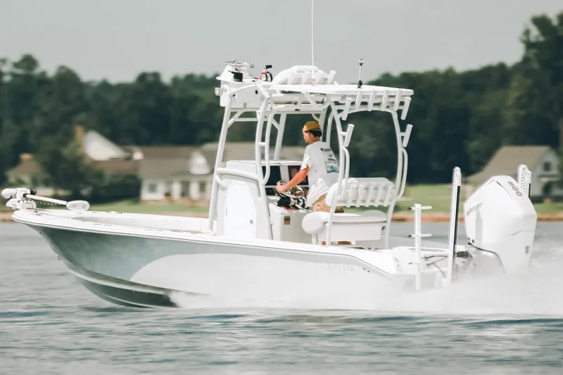 Slide: The Image of 2021 Xplor x24 Andros boat cruising on a lake with a person steering. - 13