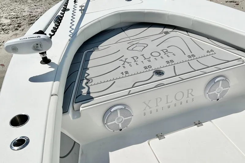 Slide: The Image of 2021 Xplor x24 Andros boat deck with speakers and Minn Kota trolling motor. - 16