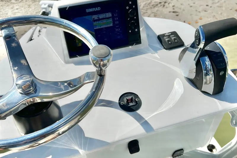 Slide: The Image of Steering console of 2021 Xplor x24 Andros boat with Simrad display and controls. - 18