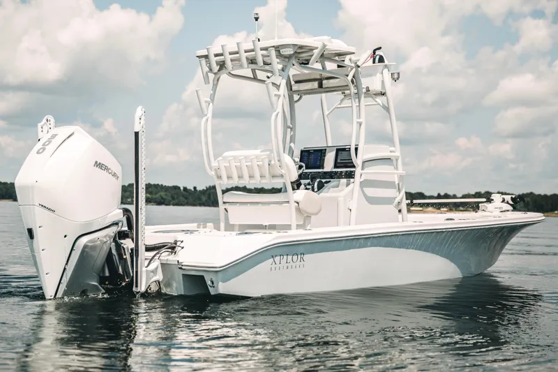 Slide: The Image of 2021 Xplor x24 Andros boat on water, featuring Mercury engine, under a cloudy sky. - 3