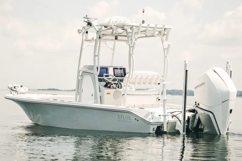 Slide: The Image of 2021 Xplor x24 Andros boat on calm water, featuring a Mercury engine. - 5