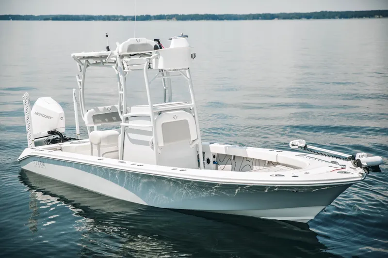 Slide: The Image of 2021 Xplor x24 Andros boat on calm water, featuring sleek design and Mercury engine. - 6