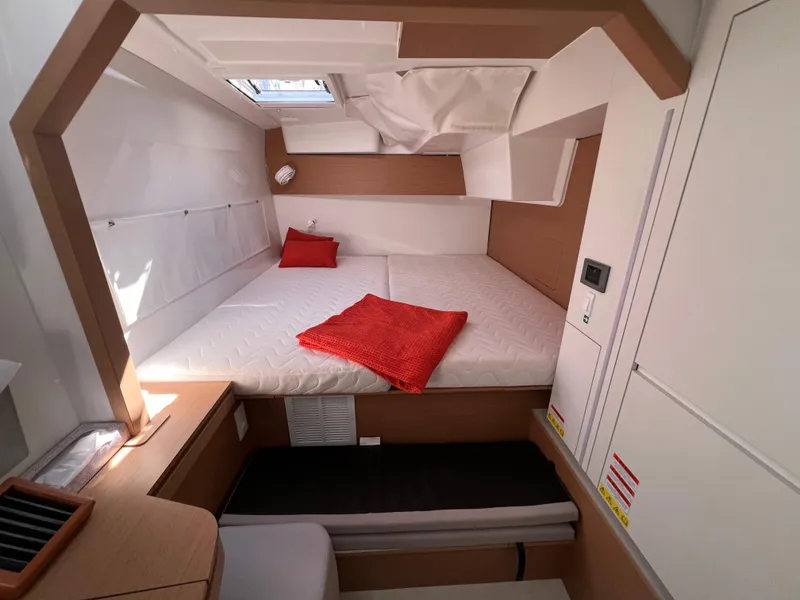 Slide: The Image of Cozy cabin interior of 2022 Excess XCS 11 yacht with red accents. - 6