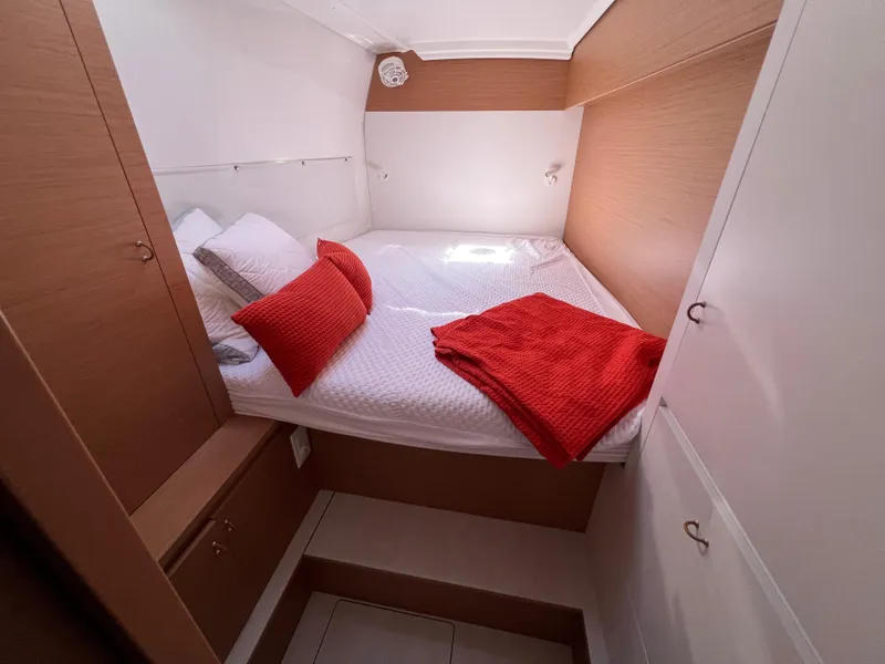 Slide: The Image of Cozy cabin interior of 2022 Excess XCS 11 with red accents and wood finish. - 9