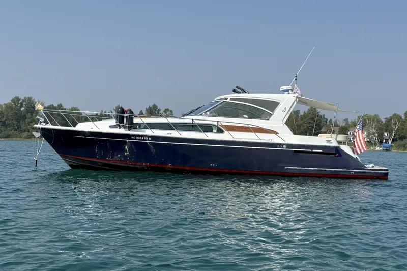 Slide: The Image of 2005 Chris-Craft Roamer 40 yacht cruising on calm waters with passengers onboard. - 0