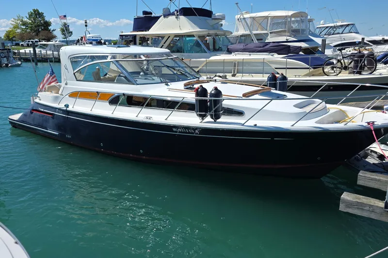 Slide: The Image of 2005 Chris-Craft Roamer 40 cruising on calm waters under a clear sky. - 1