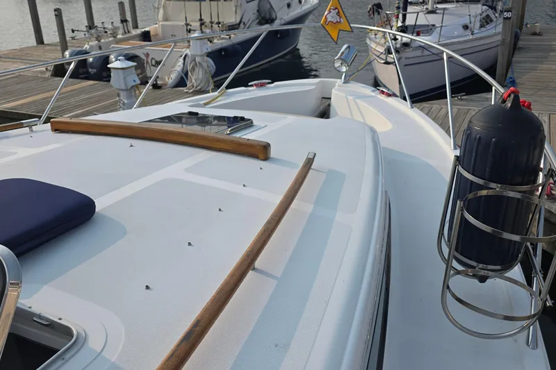 Slide: The Image of 2005 Chris-Craft Roamer 40 yacht docked, showcasing deck and railing details. - 13