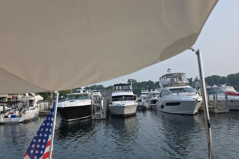 Slide: The Image of Boats docked at a marina, featuring a 2005 Chris-Craft Roamer 40. - 16