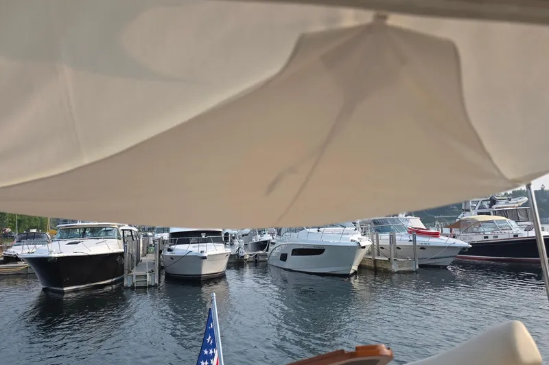 Slide: The Image of Boats docked at a marina, featuring a 2005 Chris-Craft Roamer 40. - 17