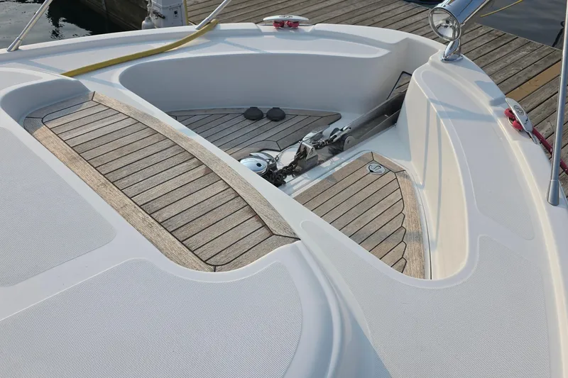 Slide: The Image of 2005 Chris-Craft Roamer 40 boat deck with wood finish and anchor detail. - 18