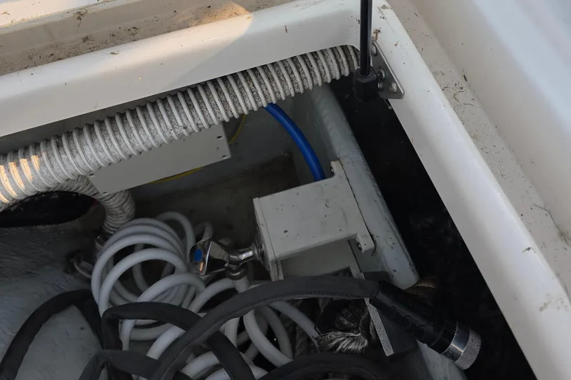 Slide: The Image of 2005 Chris-Craft Roamer 40 boat interior showing coiled hoses and wiring. - 19