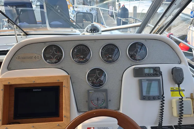 Slide: The Image of 2005 Chris-Craft Roamer 40 dashboard with gauges and navigation equipment. - 21