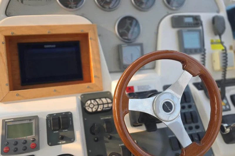 Slide: The Image of 2005 Chris-Craft Roamer 40 helm with wooden steering wheel and navigation instruments. - 22