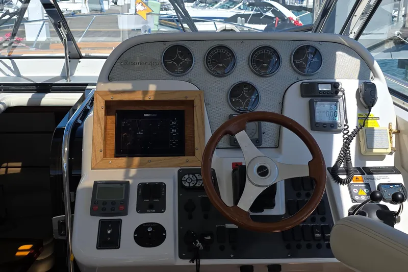 Slide: The Image of 2005 Chris-Craft Roamer 40 helm with gauges, steering wheel, and navigation equipment. - 23
