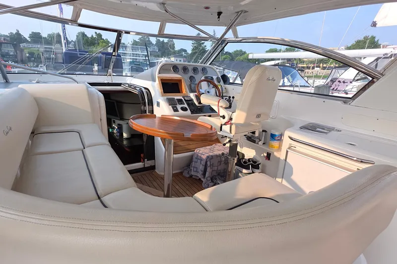 Slide: The Image of 2005 Chris-Craft Roamer 40 yacht interior with helm, seating, and wooden table. - 26
