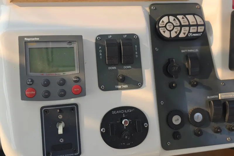 Slide: The Image of Control panel of 2005 Chris-Craft Roamer 40 with navigation and trim tab controls. - 27