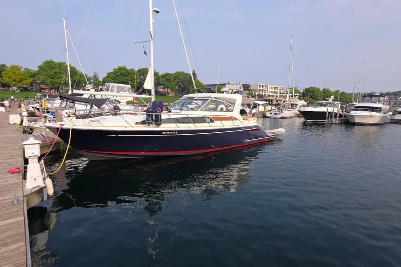 Slide: The Image of 2005 Chris-Craft Roamer 40 yacht docked in a marina, featuring sleek design and American flag. - 3