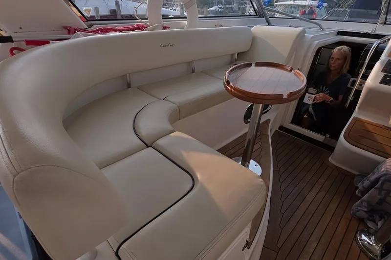 Slide: The Image of 2005 Chris-Craft Roamer 40 yacht interior with cream seating and wooden table. - 34