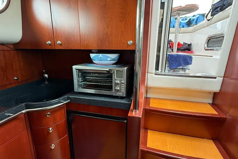 Slide: The Image of Luxurious 2005 Chris-Craft Roamer 40 yacht interior with wooden cabinetry and modern appliances. - 37