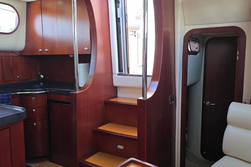 Slide: The Image of Interior of 2005 Chris-Craft Roamer 40 yacht with wooden cabinetry and stairs. - 41