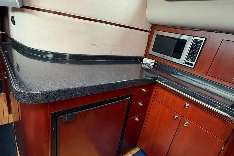 Slide: The Image of Luxurious 2005 Chris-Craft Roamer 40 yacht kitchen with sleek countertops and modern appliances. - 42
