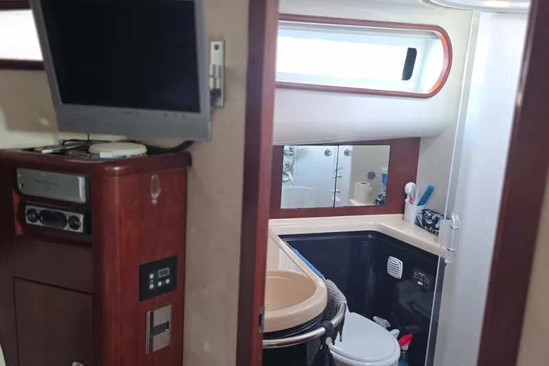Slide: The Image of 2005 Chris-Craft Roamer 40 yacht interior with bathroom and entertainment system. - 44