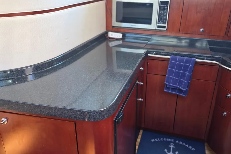Slide: The Image of Luxurious 2005 Chris-Craft Roamer 40 yacht kitchen with sleek countertops and modern appliances. - 52