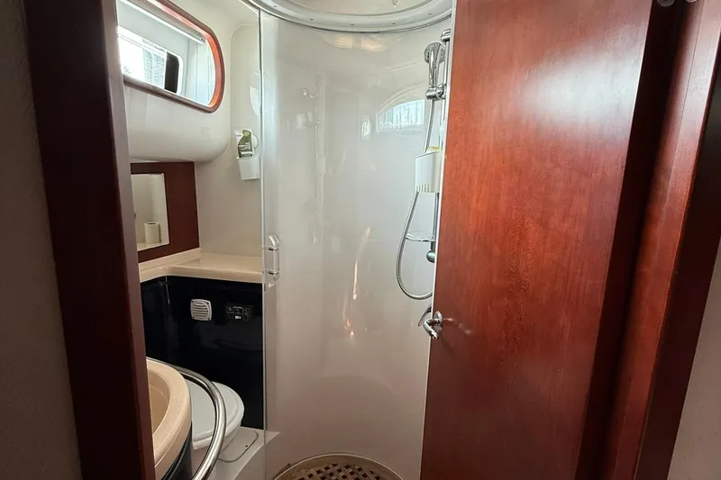 Slide: The Image of 2005 Chris-Craft Roamer 40 yacht bathroom with shower, wooden door, and modern fixtures. - 62