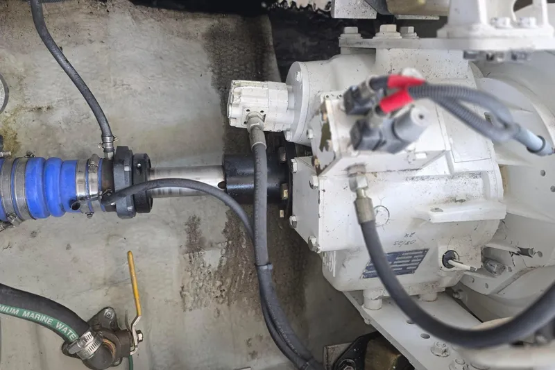 Slide: The Image of Engine compartment of a 2005 Chris-Craft Roamer 40, showcasing mechanical components and hoses. - 77