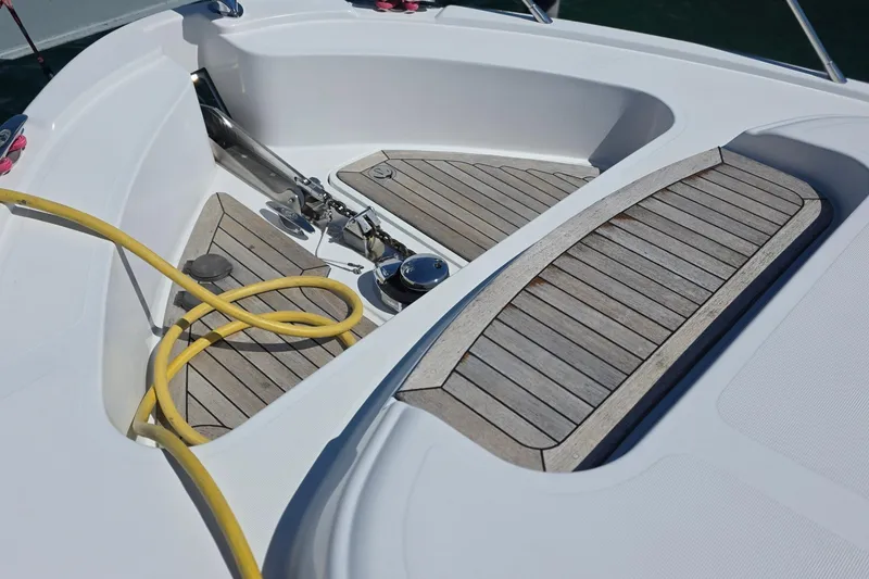 Slide: The Image of 2005 Chris-Craft Roamer 40 boat deck with wooden panels and yellow hose. - 81