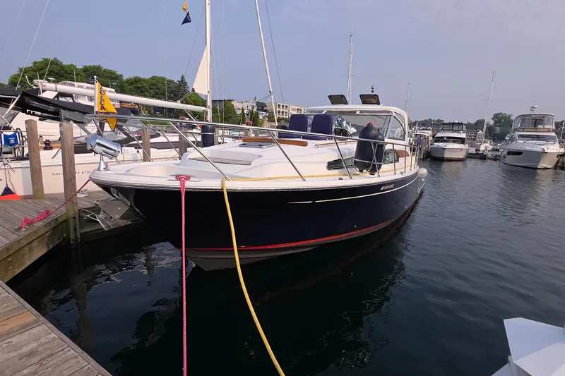 Slide: The Image of 2005 Chris-Craft Roamer 40 yacht docked in a marina, surrounded by other boats. - 9
