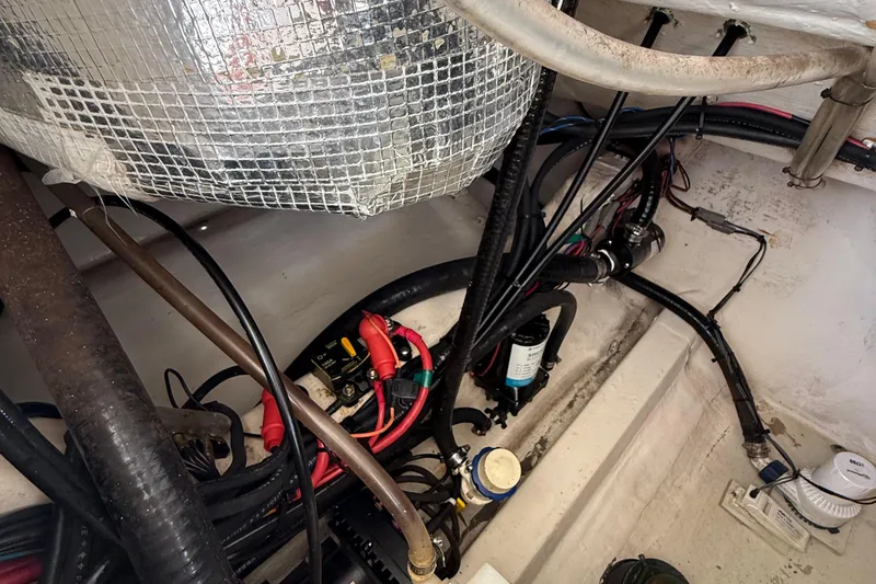 Slide: The Image of Engine compartment of a 2015 Cobia 296 Center Console with wiring and components. - 10