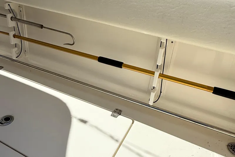 Slide: The Image of 2015 Cobia 296 Center Console boat interior with fishing rod holder. - 15